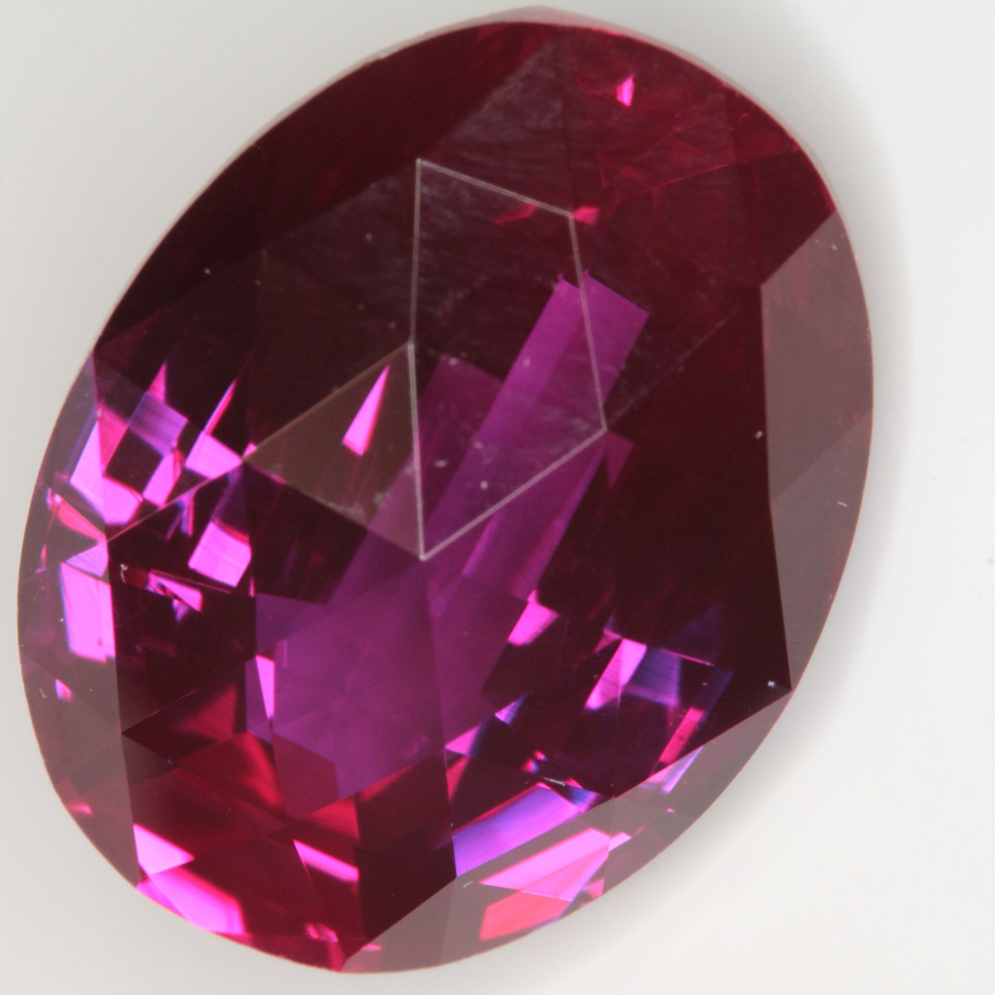 Faceted Flame Fusion Ruby Checkerboard Bent Oval Gemstone