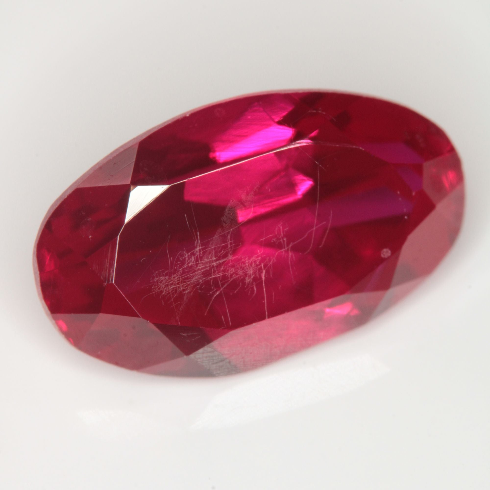 Faceted Flame Fusion Ruby Oval (scratched) Gemstone