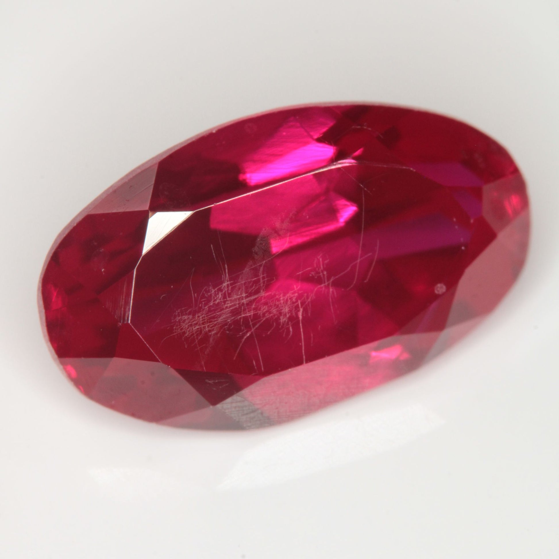 Faceted Flame Fusion Ruby Oval (scratched) Gemstone