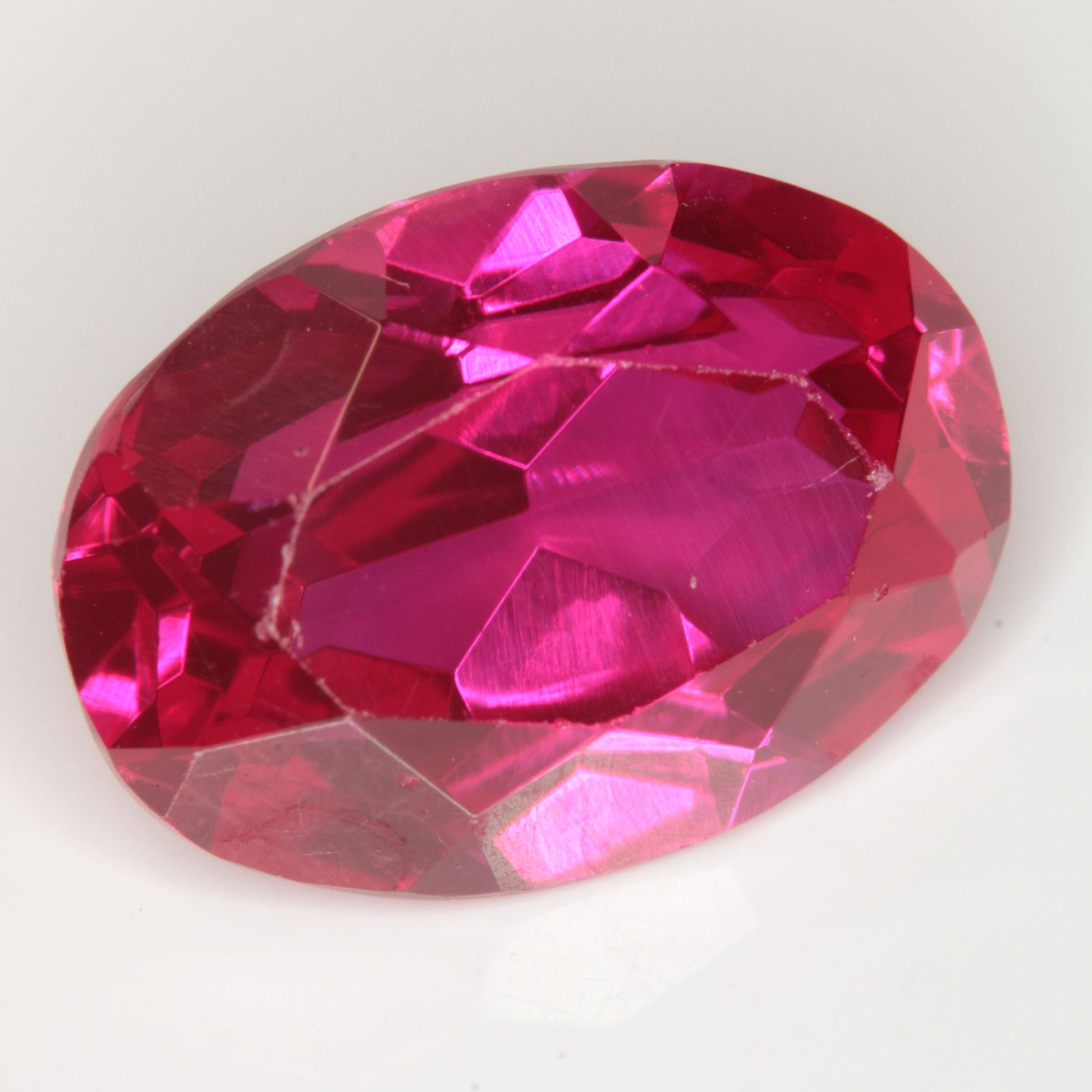 Faceted Flame Fusion Ruby Oval Gemstone