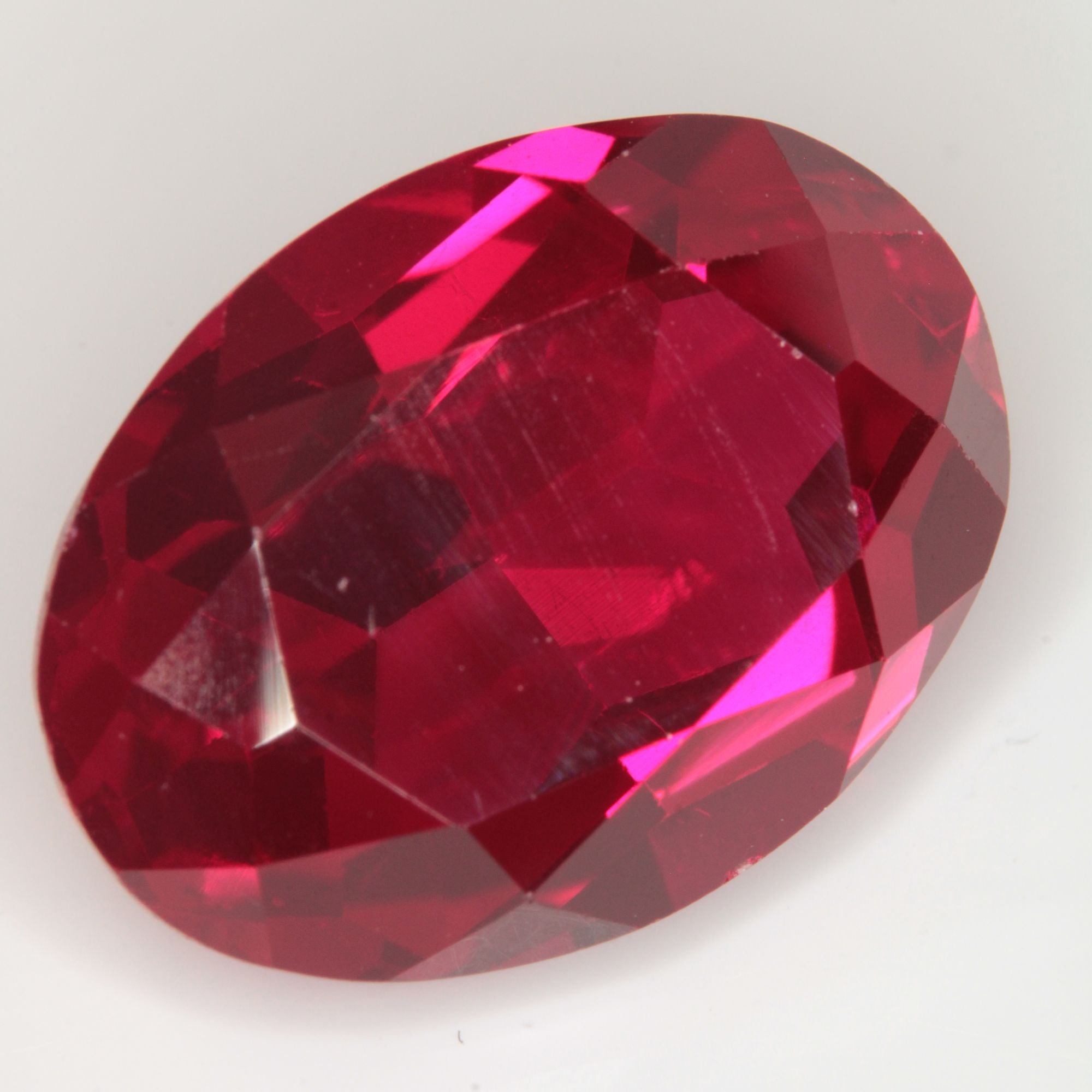 Faceted Flame Fusion Ruby Oval Gemstone