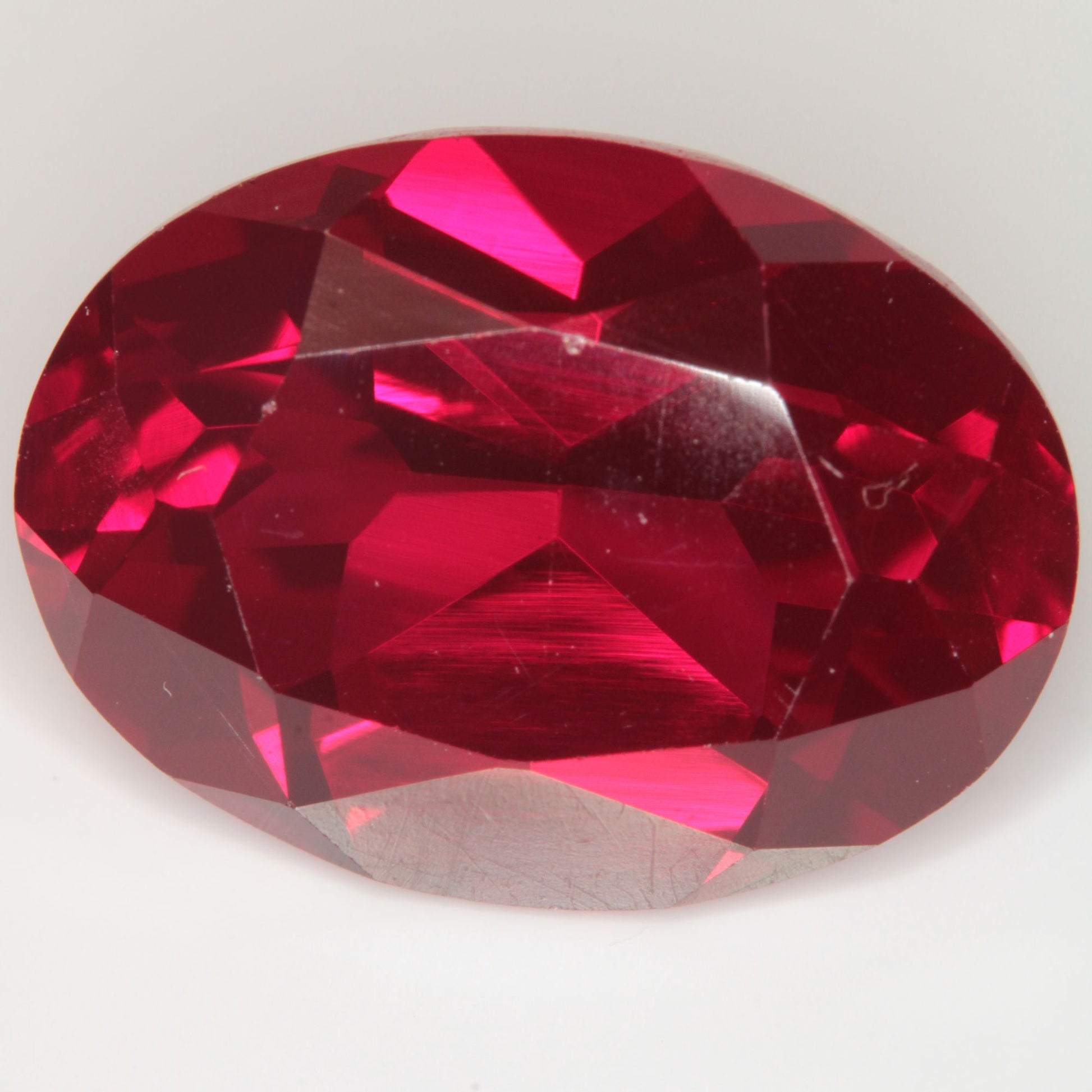 Faceted Flame Fusion Ruby Oval Gemstone