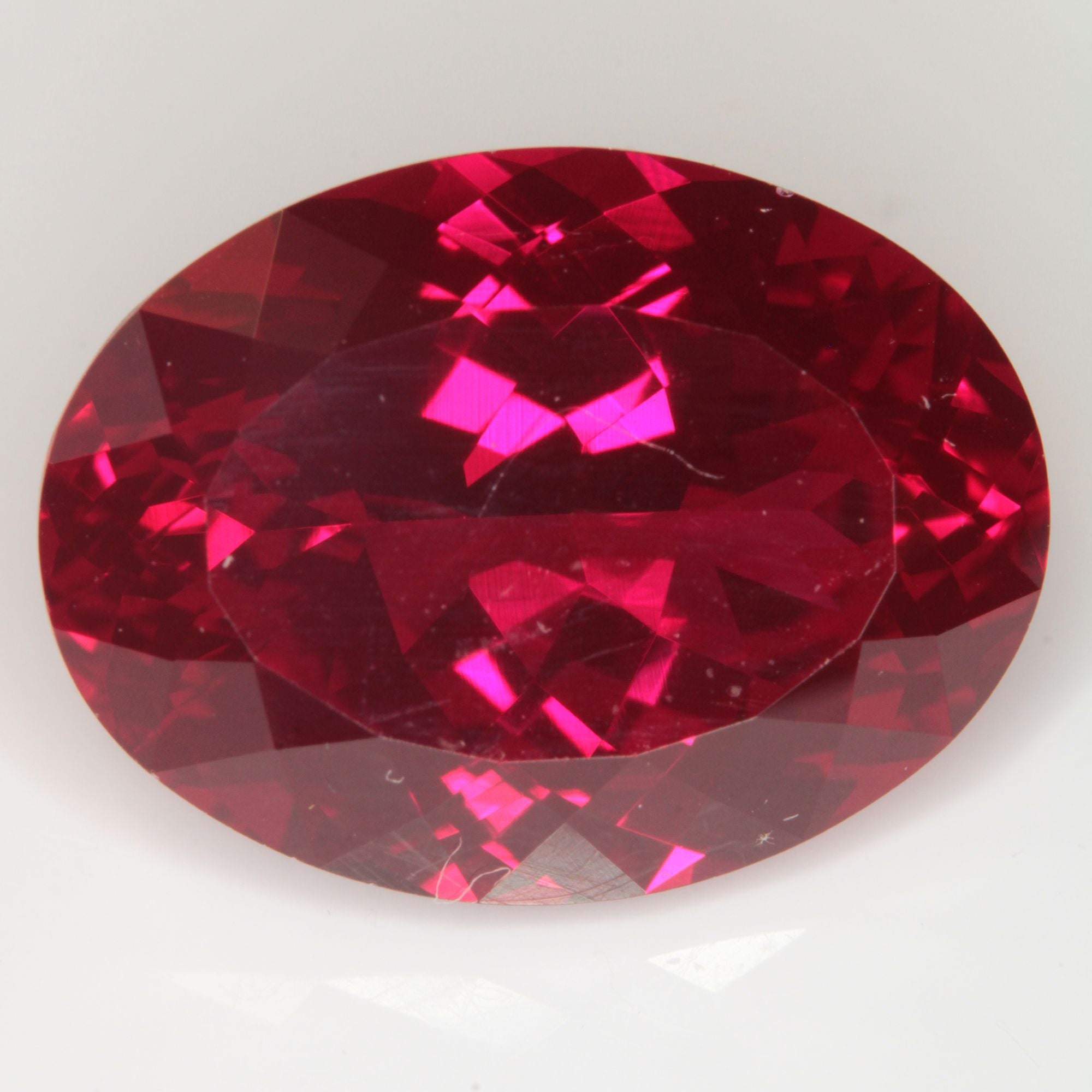 Faceted Flame Fusion Ruby Oval Gemstone