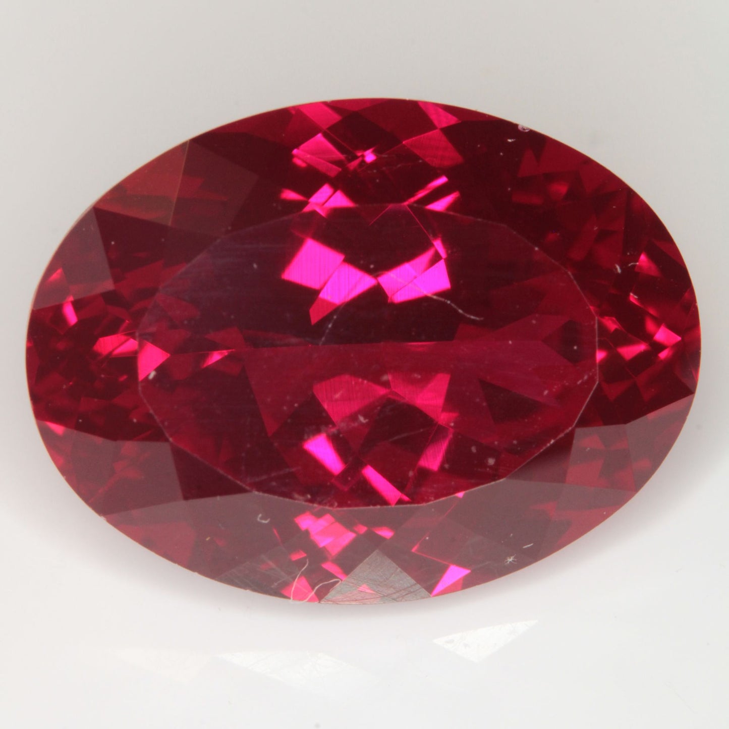 Faceted Flame Fusion Ruby Oval Gemstone