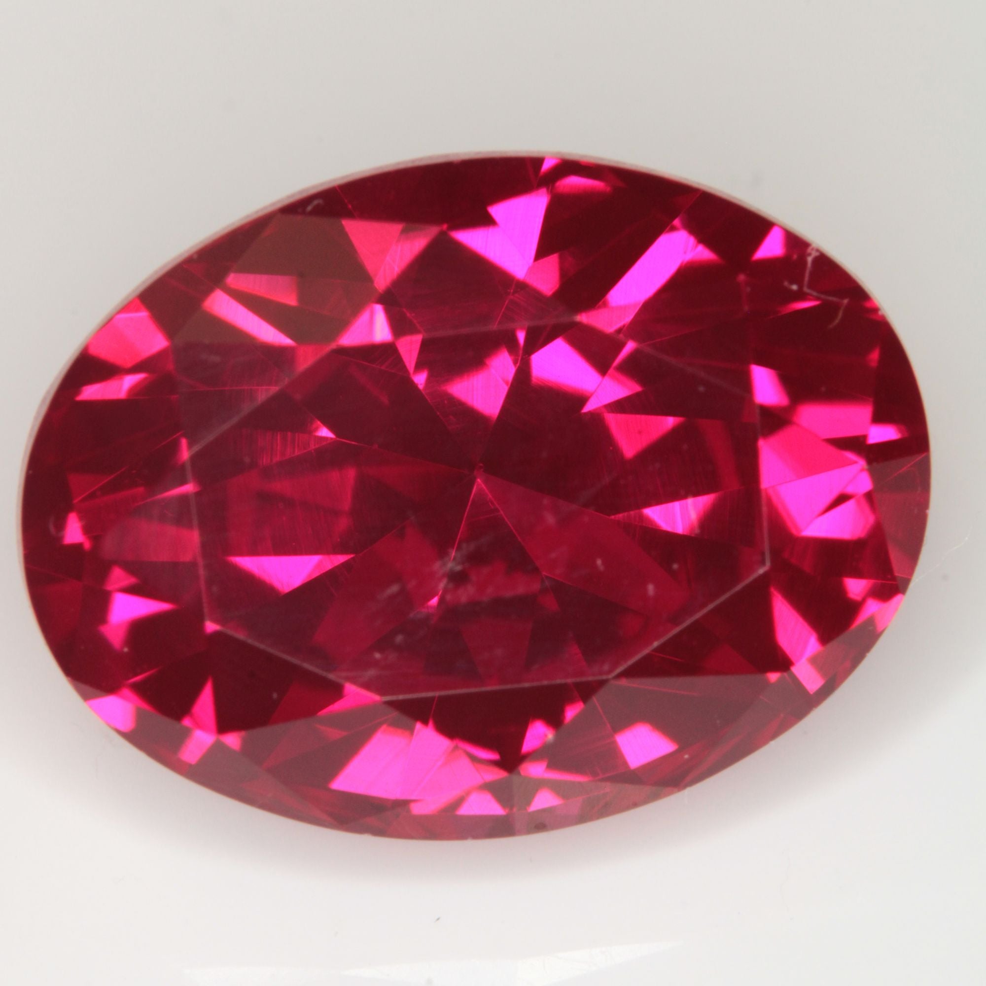 Faceted Flame Fusion Ruby Oval Gemstone