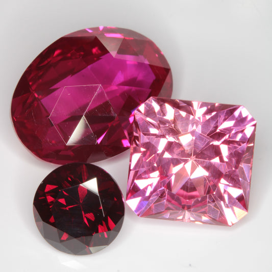Three Soviet-grown Flame Fusion Rubies, showing the different intensities ranging from dark red to light pink.