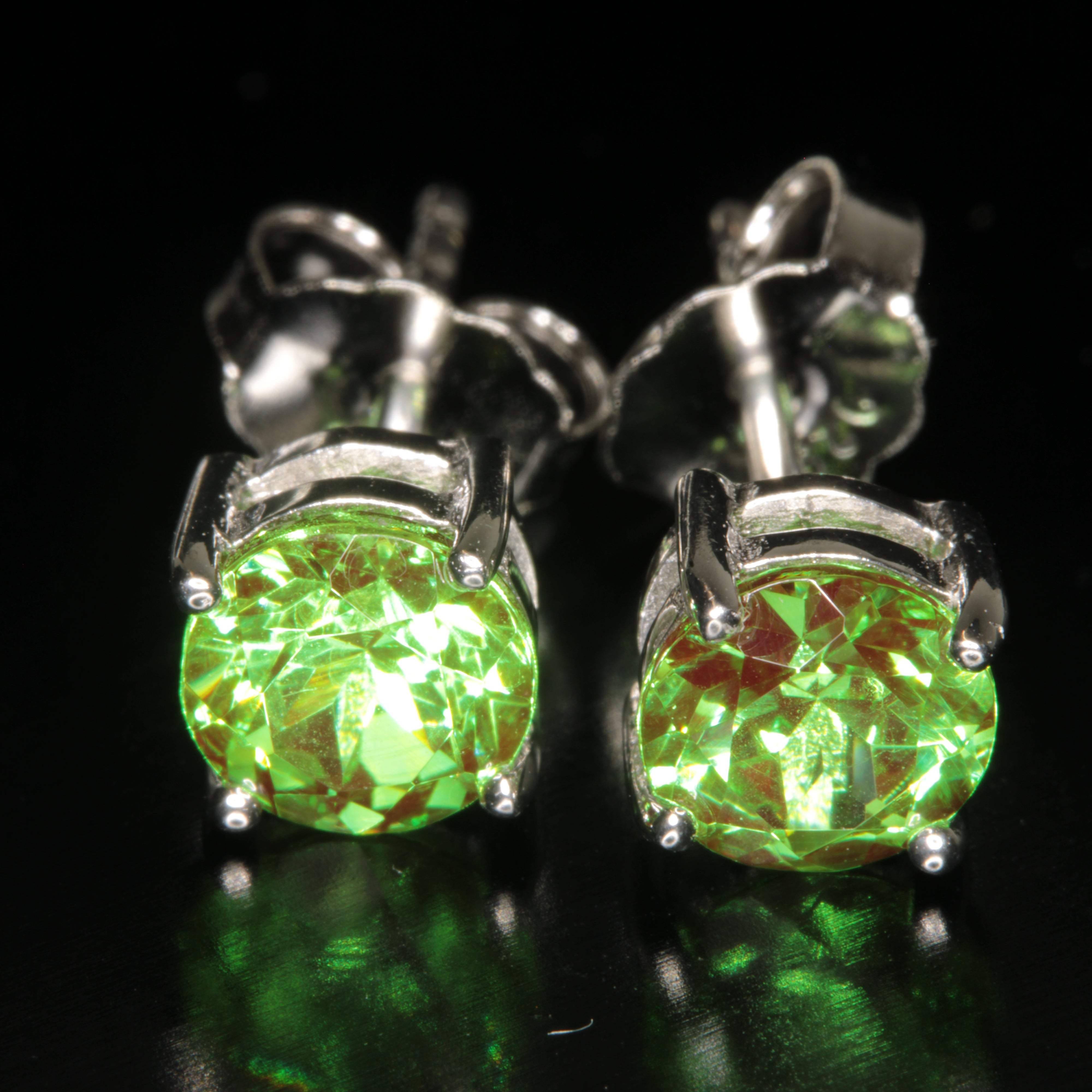 Space Laser Garnet Stud Earrings shown under different lighting conditions