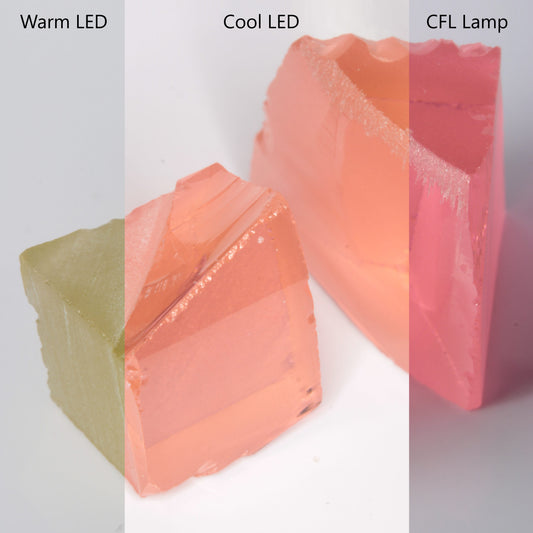 Erbium YAG under four different colored lights, showing the color change from orange to pink to yellow to magenta