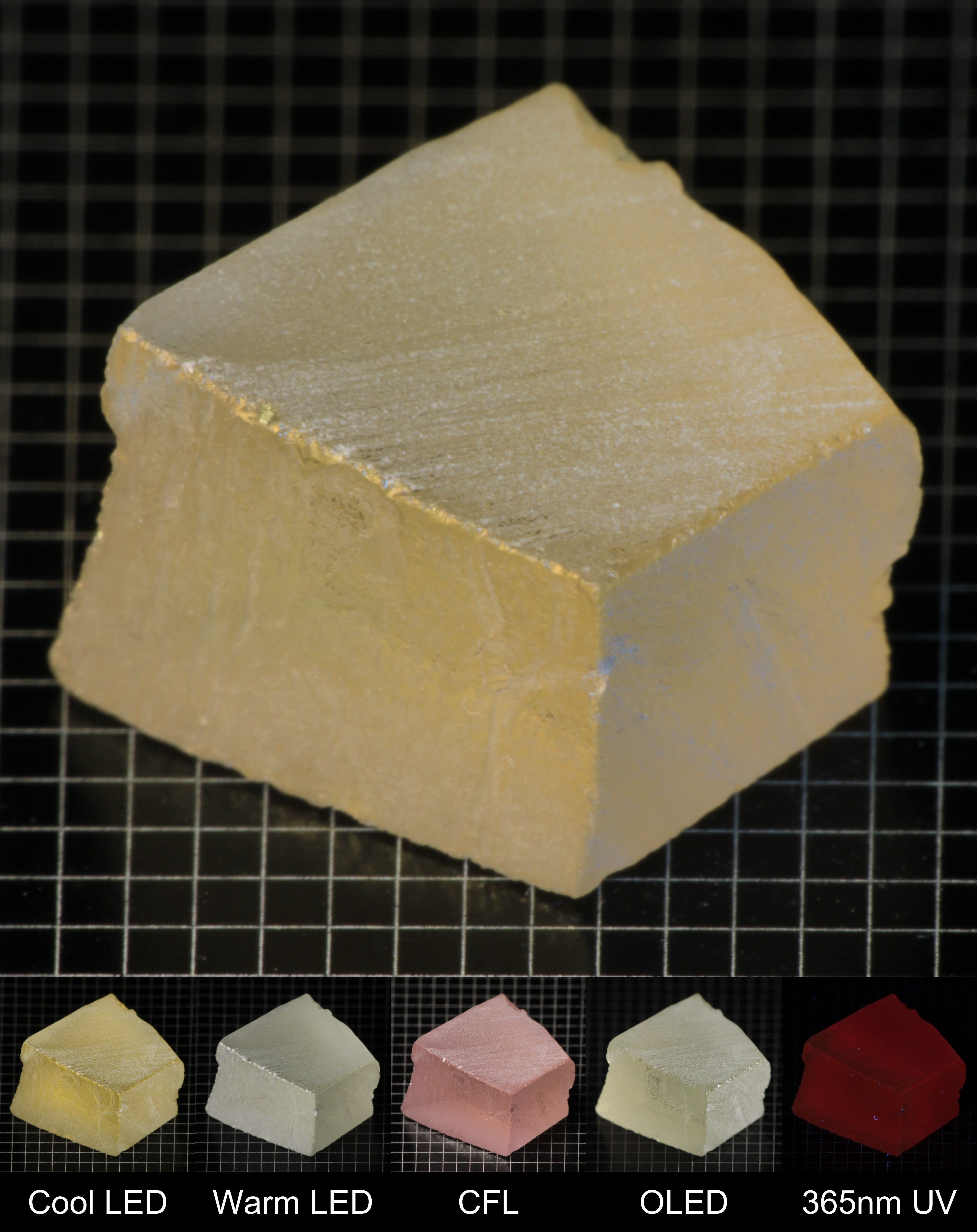 Darker Block of Ho:YAG Gem Rough, showing color changes from yellow to pink under different lighting conditions.