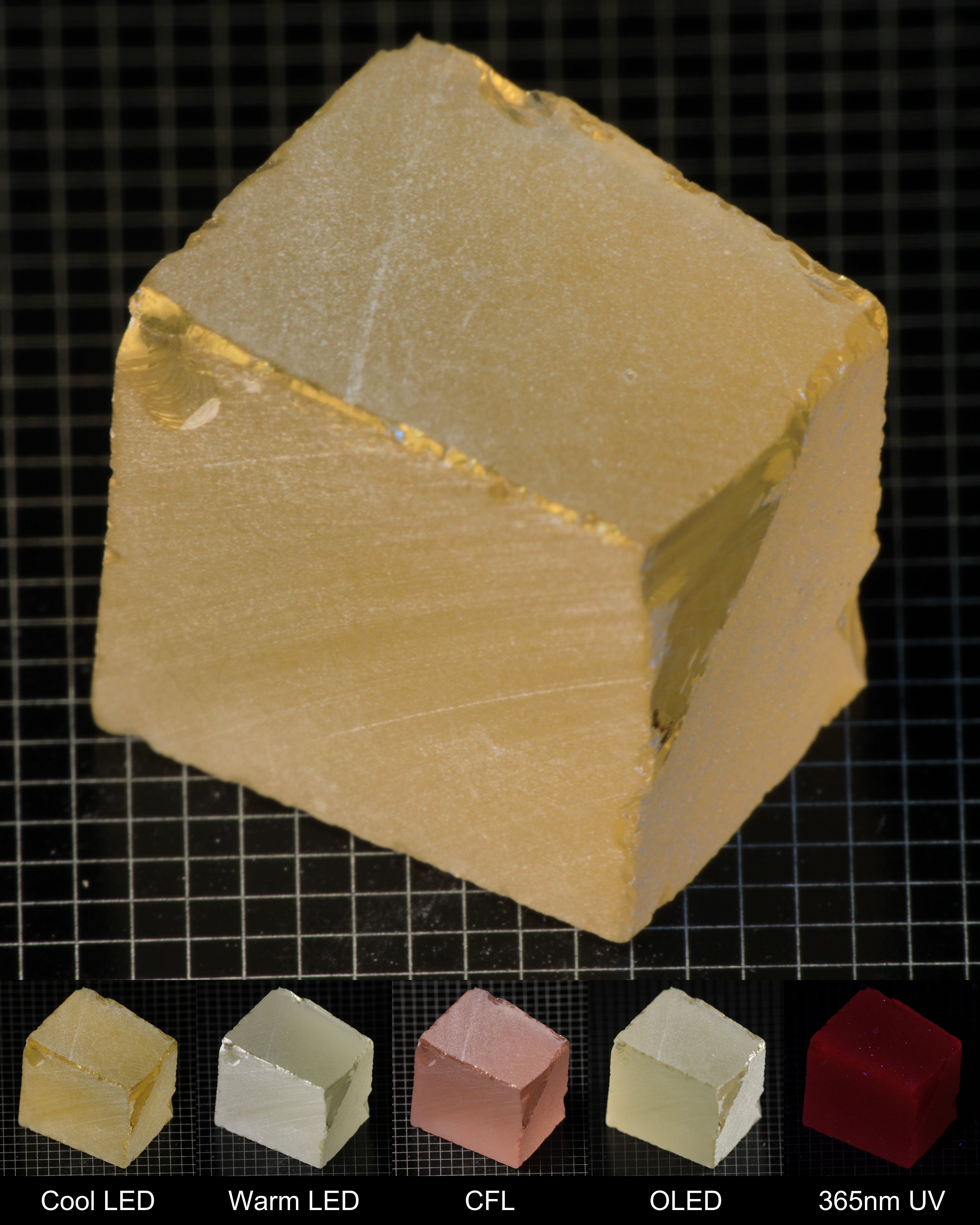 Darker Block of Ho:YAG Gem Rough, showing color changes from yellow to pink under different lighting conditions.