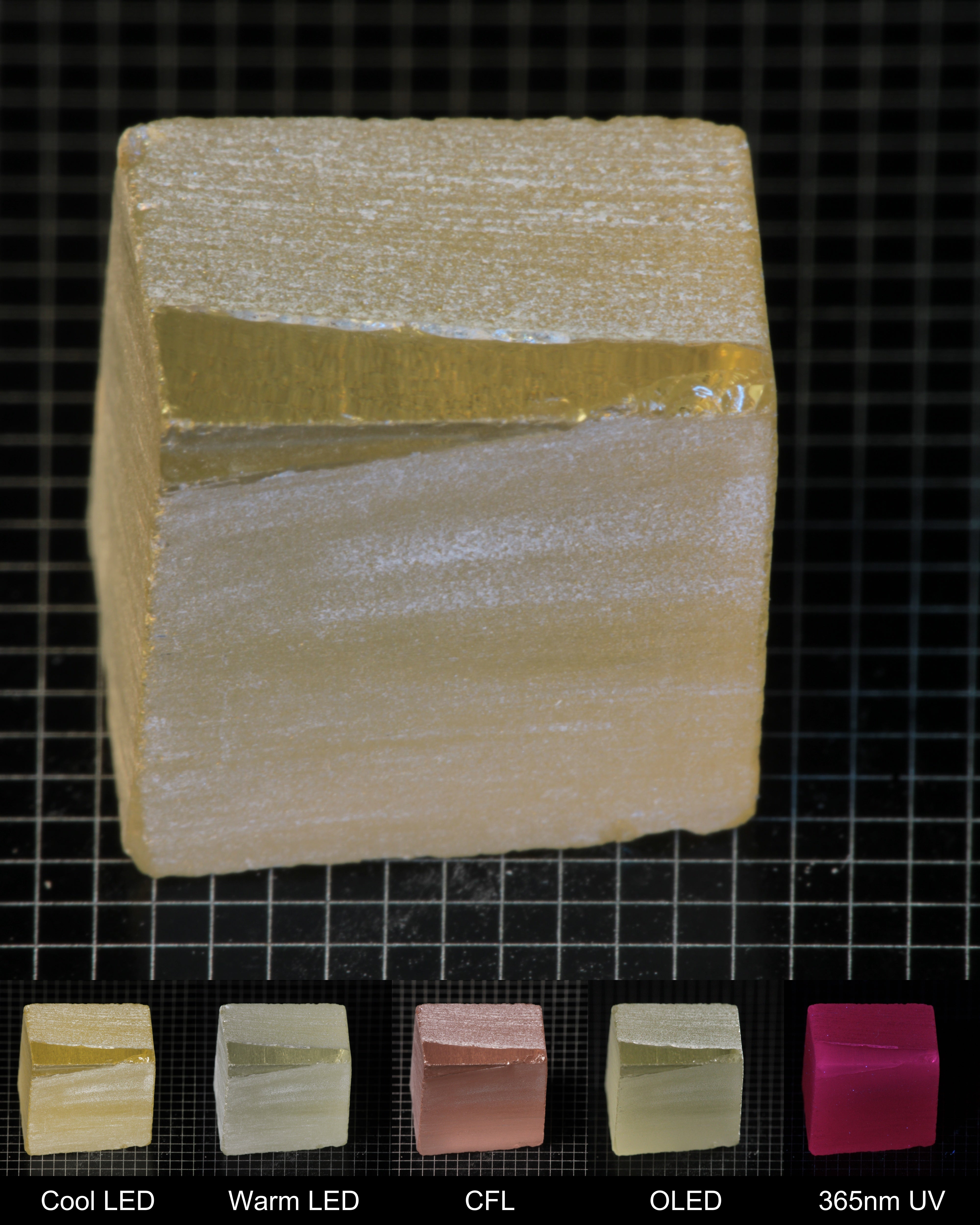 Darker Block of Ho:YAG Gem Rough, showing color changes from yellow to pink under different lighting conditions.