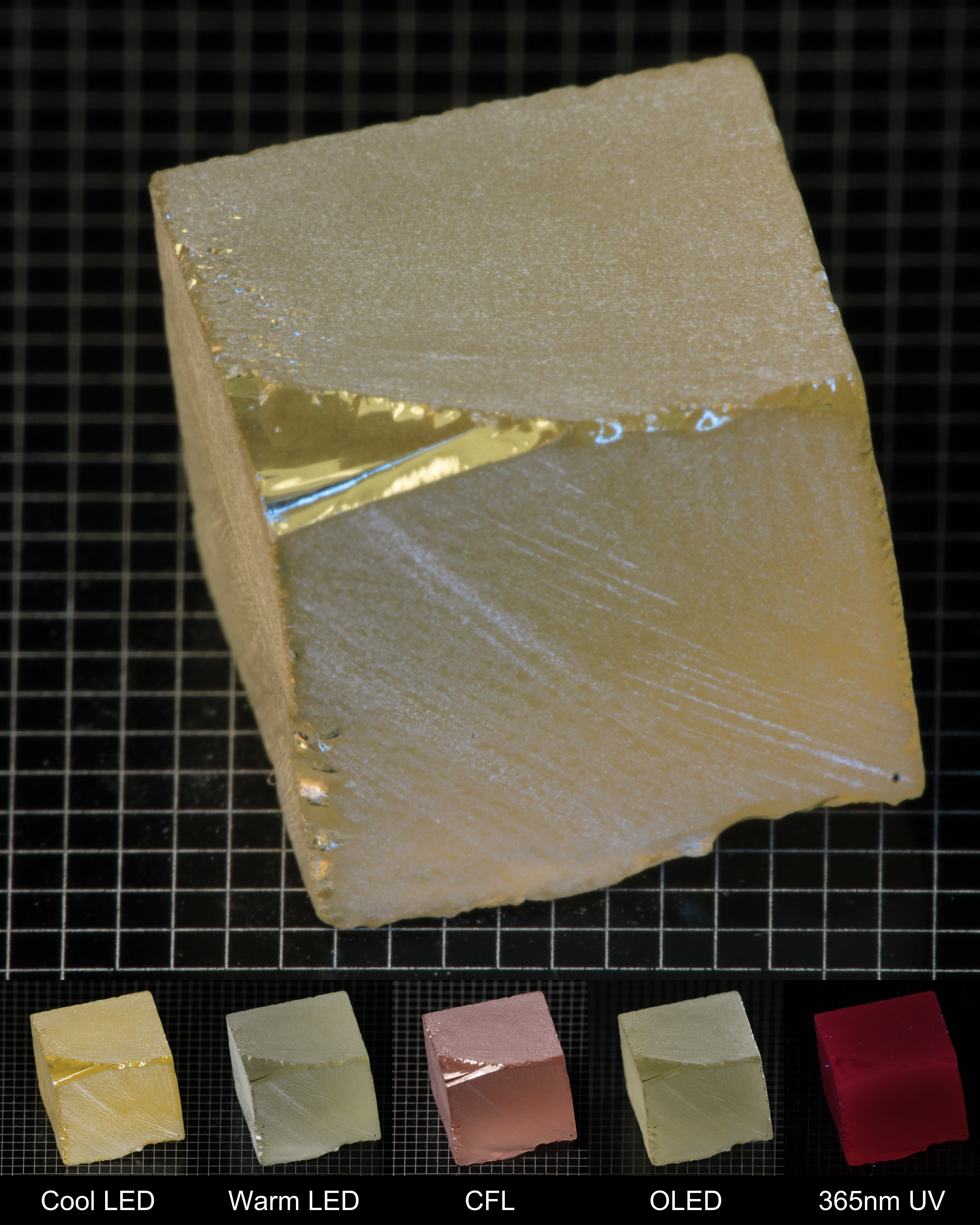 Darker Block of Ho:YAG Gem Rough, showing color changes from yellow to pink under different lighting conditions.