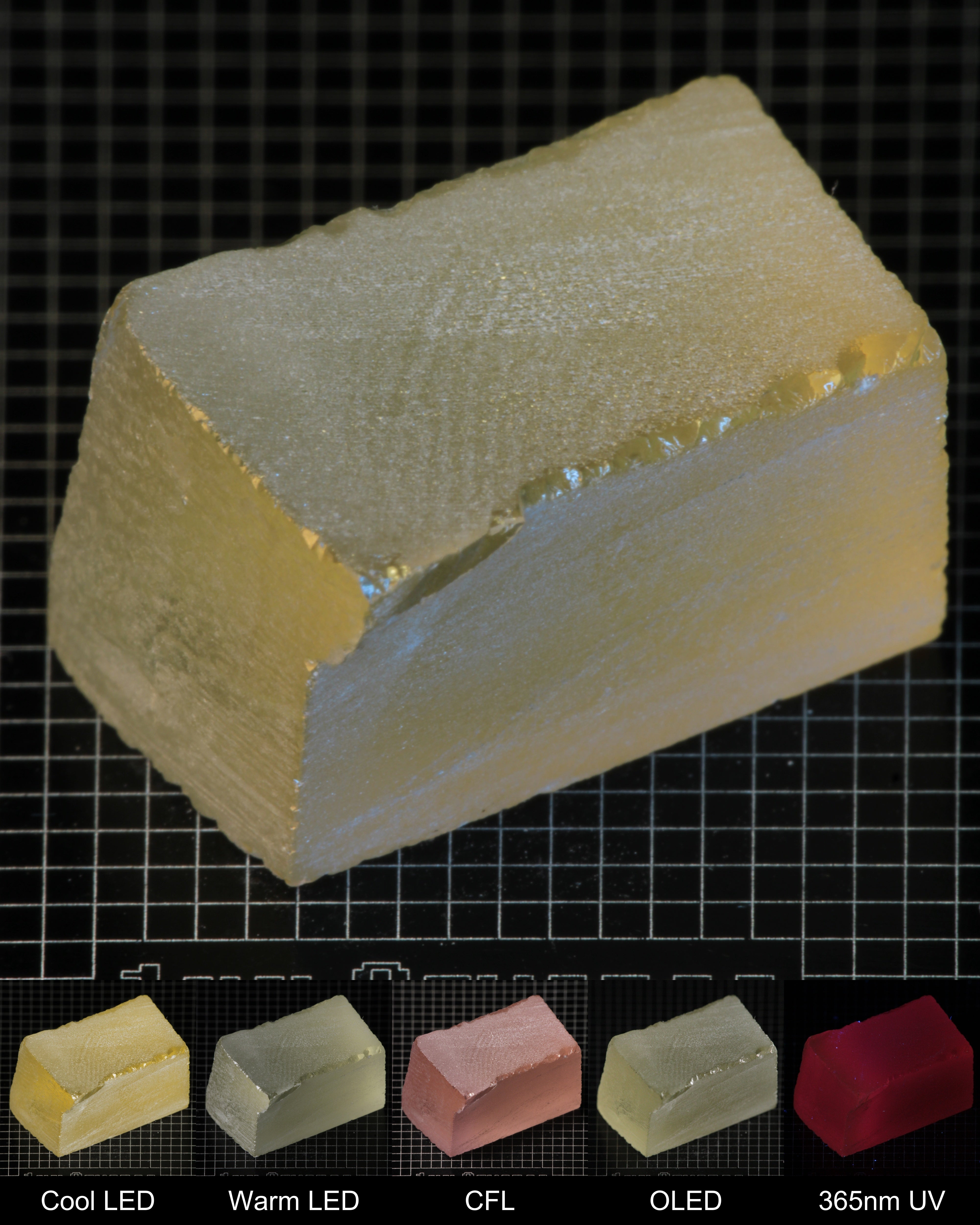 Darker Block of Ho:YAG Gem Rough, showing color changes from yellow to pink under different lighting conditions.