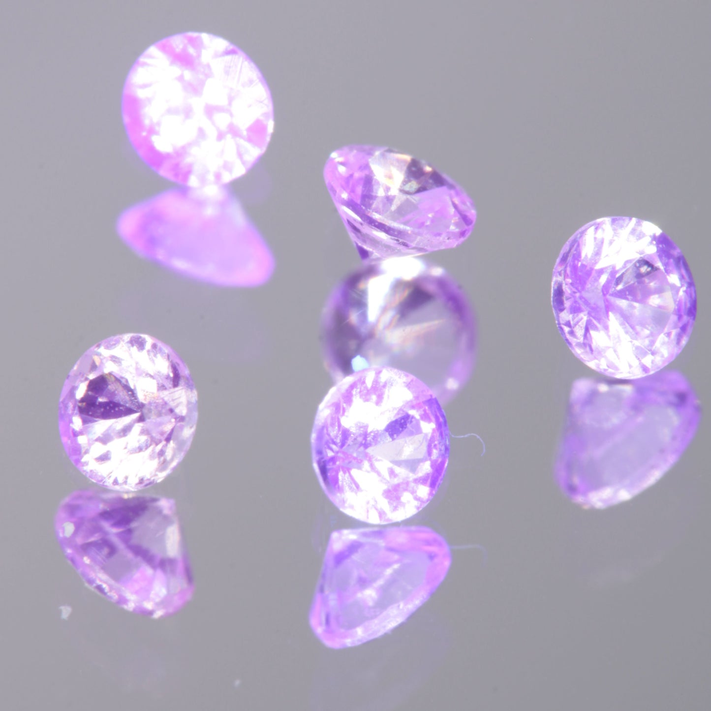 Faceted 2mm Round (Pink Glow) YAG:Nd:Ce Gemstone