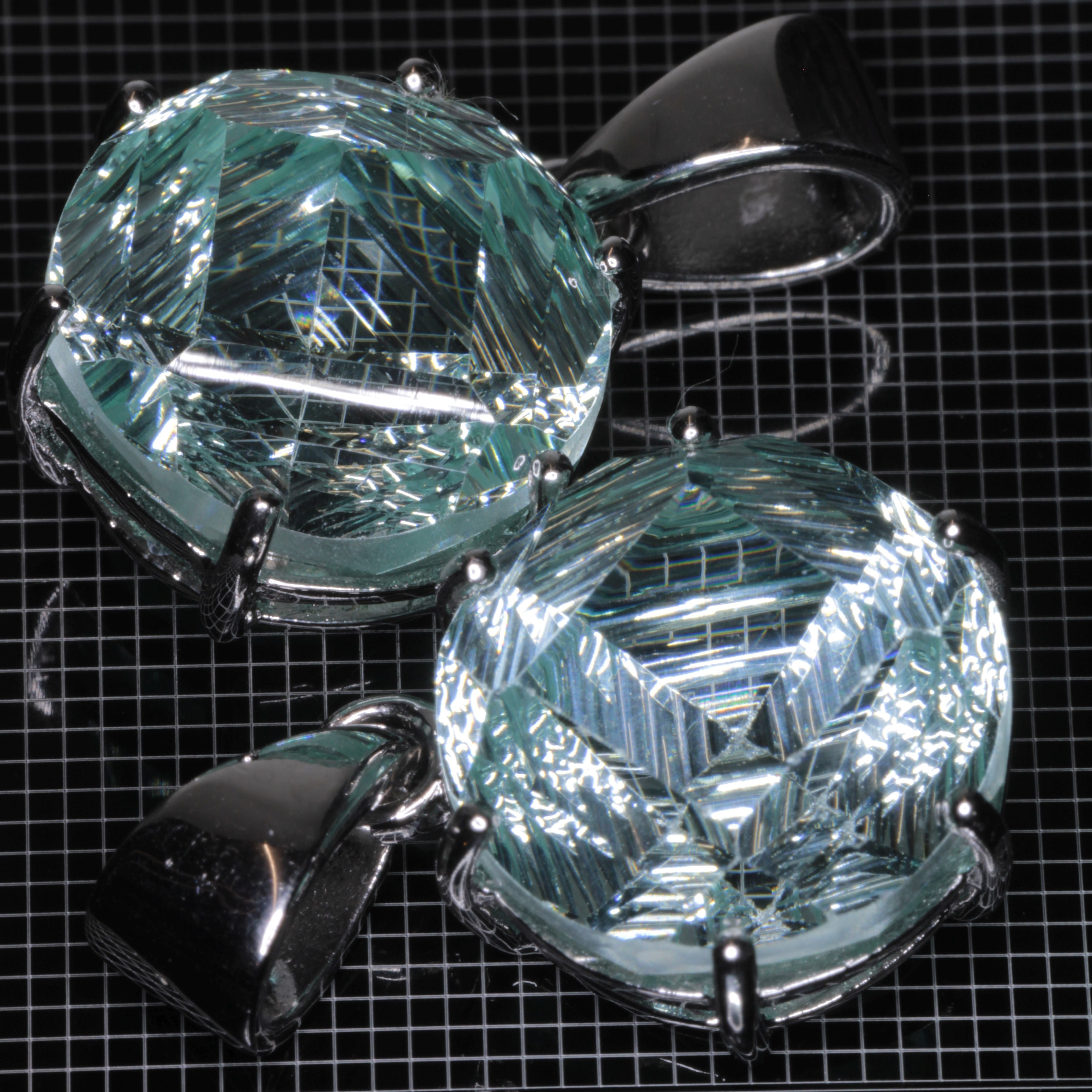 Fantasy Cut Light Blue Yb:YAG gemstones in sterling silver pendants