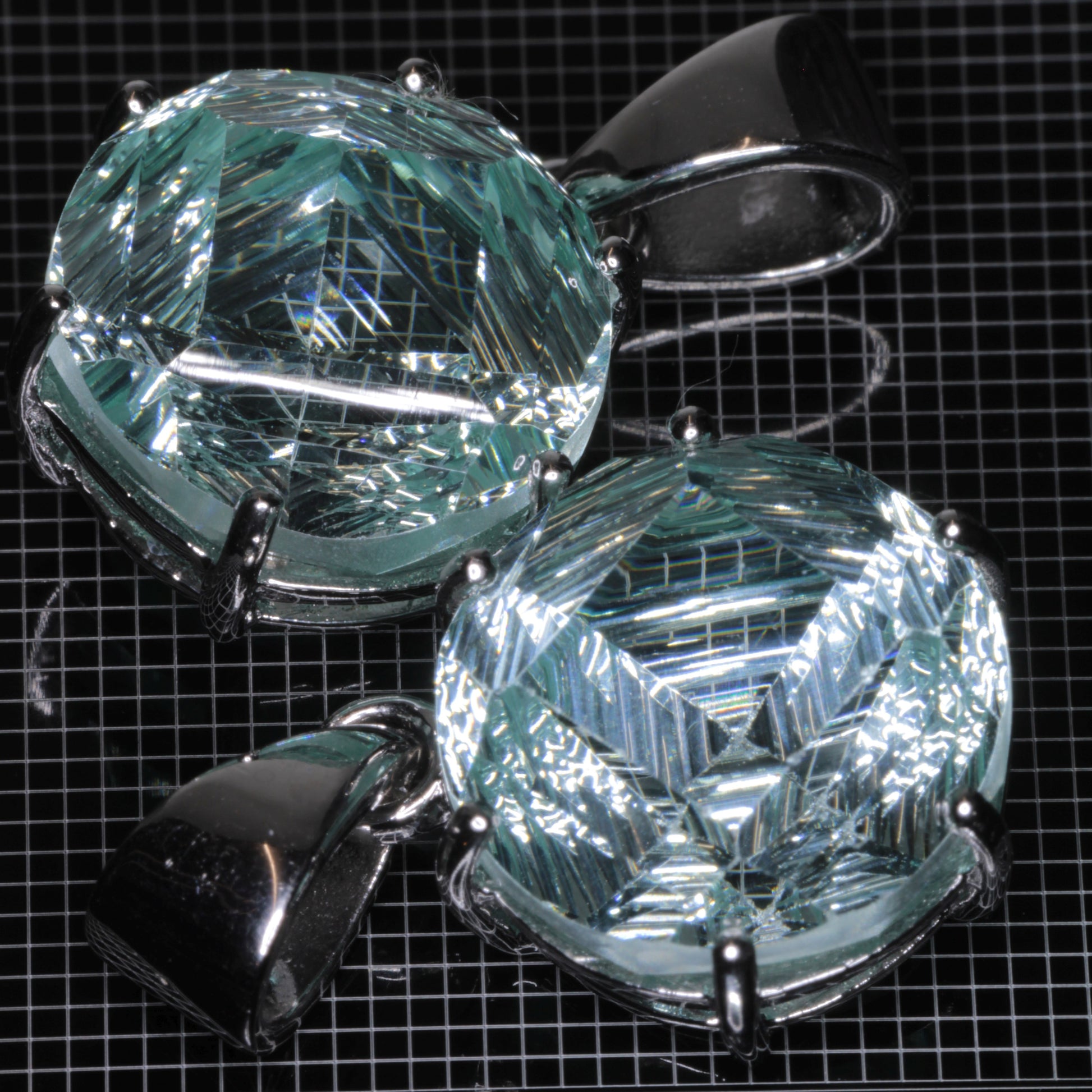 Fantasy Cut Light Blue Yb:YAG gemstones in sterling silver pendants