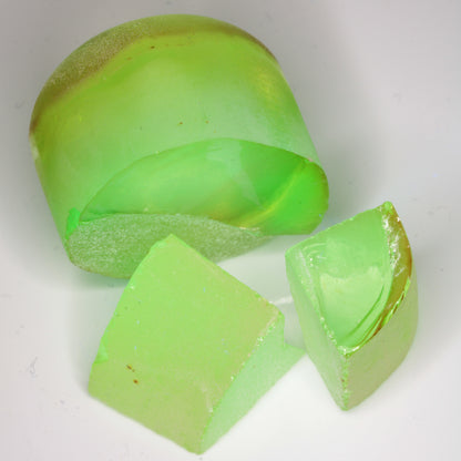 Yellow Flame Fusion Spinel under combined normal LED lighting and 365nm UV, showing the bright green fluorescence