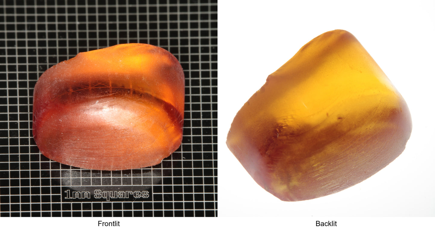 Rough Orange Flame Fusion Sapphire, Semicircle Tail Shaped Piece shown in both normal light and backlit.